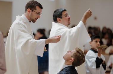Fr. Jonathon and Fr. Jorge offer Communion
