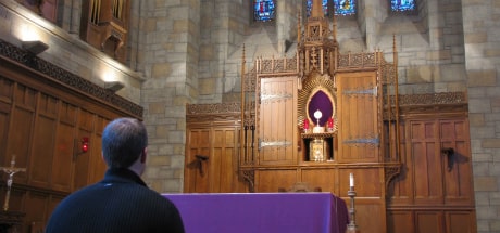 Person kneeling in St. Clement's Shrine