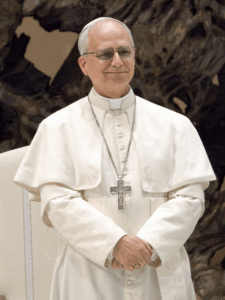 Pope Leo XIV smiling with his hands folded