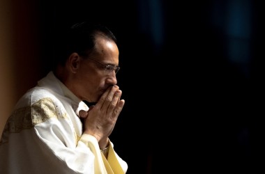 Fr. Mark Yavarone, OMV, prays during Mass