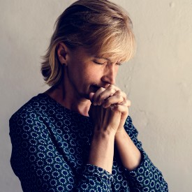 Woman praying a Novena