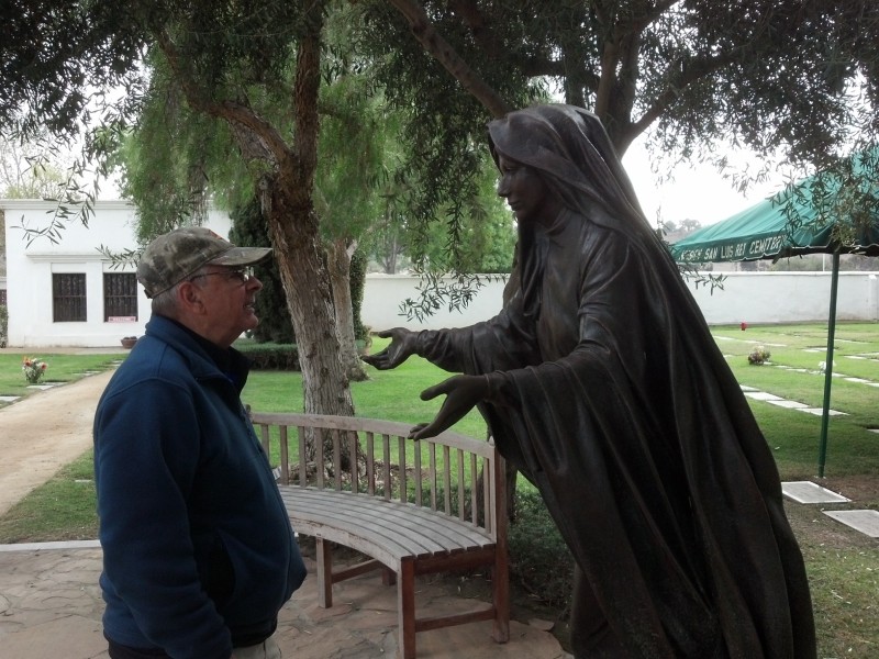 Br. Lou in front of a statue of the Virgin Mary