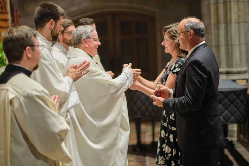 A priest welcomes seminarians