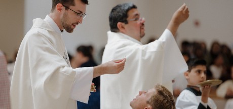 Fr. Jonathon and Fr. Jorge offer communion