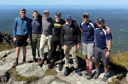 A group of Oblates and seminarians poses on a mountaintop after a hike