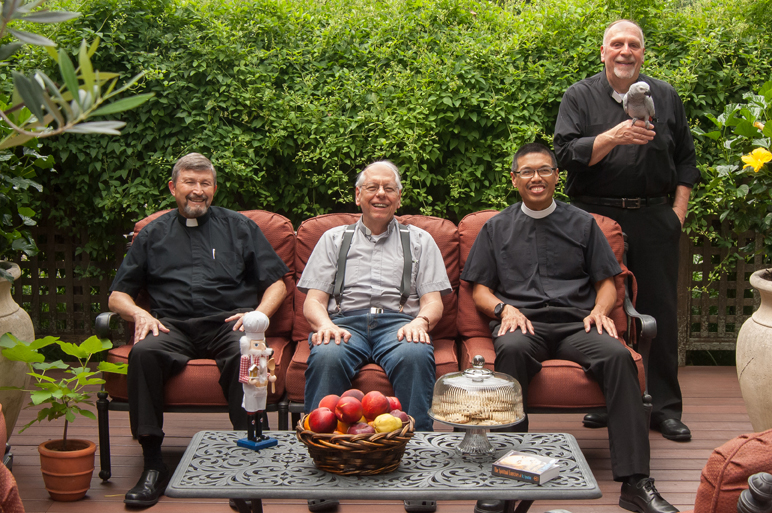 The St. Joseph Retreat House team is seated on a couch. Fr. John is seated in the middle.
