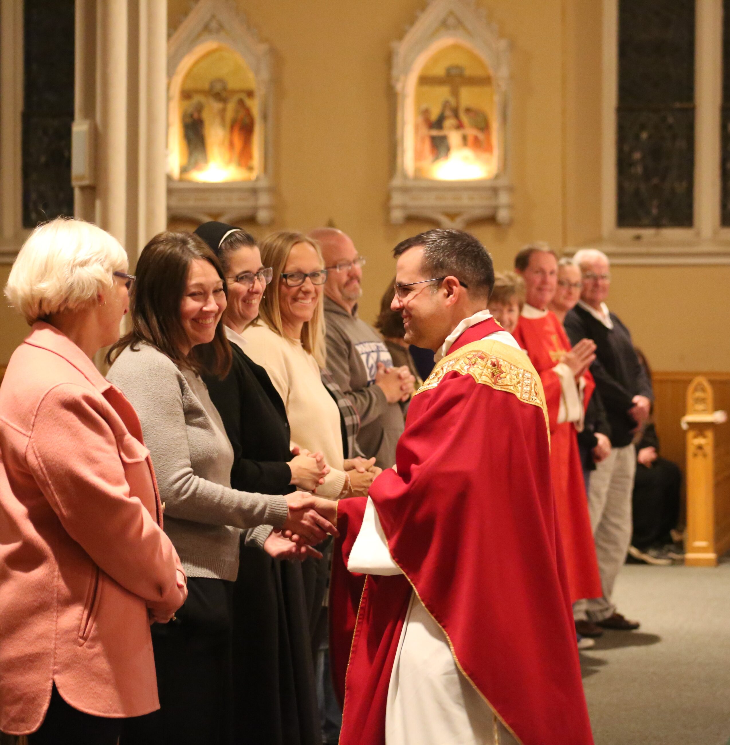 Fr. Nathan greets parishioners after Mass