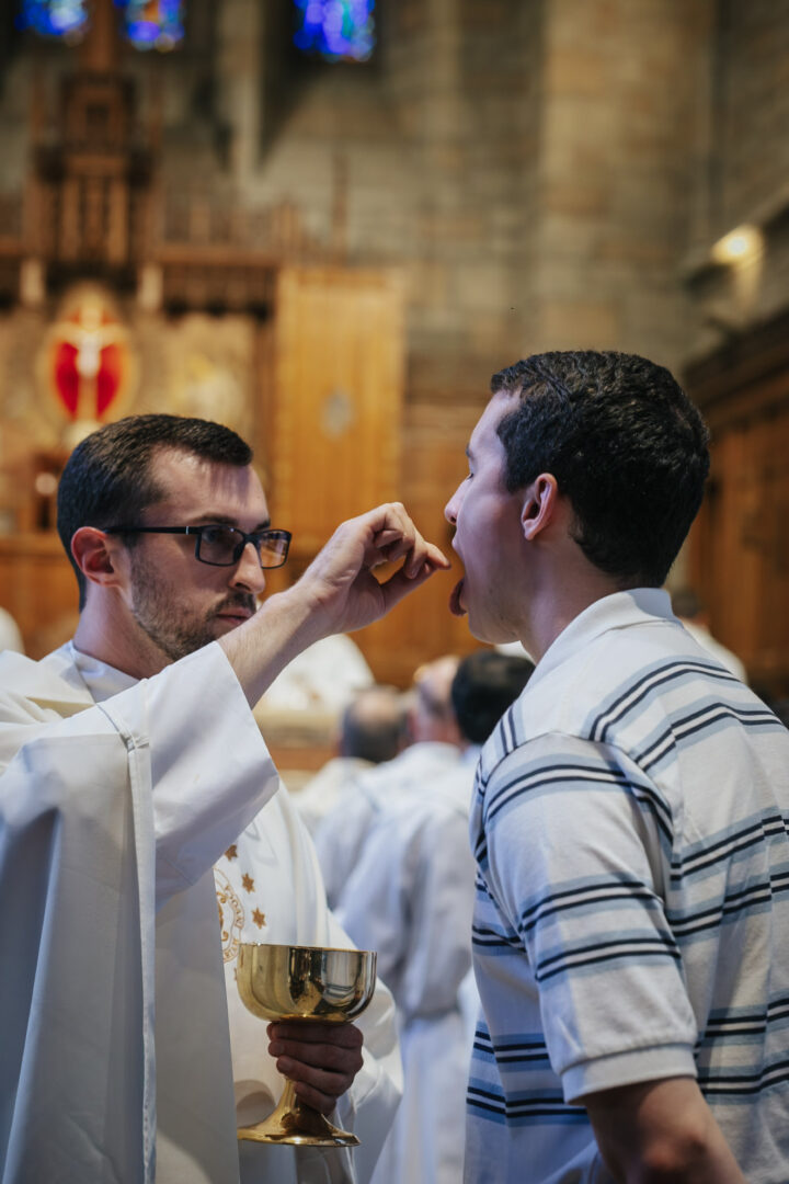 OMV priest gives Communion